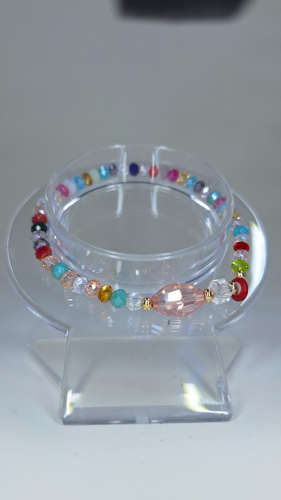 Multicolor crystal bracelet with Turkish eye and white cube.