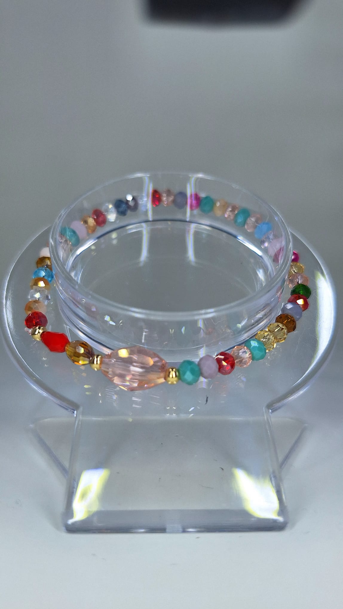 Multicolor crystal bracelet with gold laminated separator.