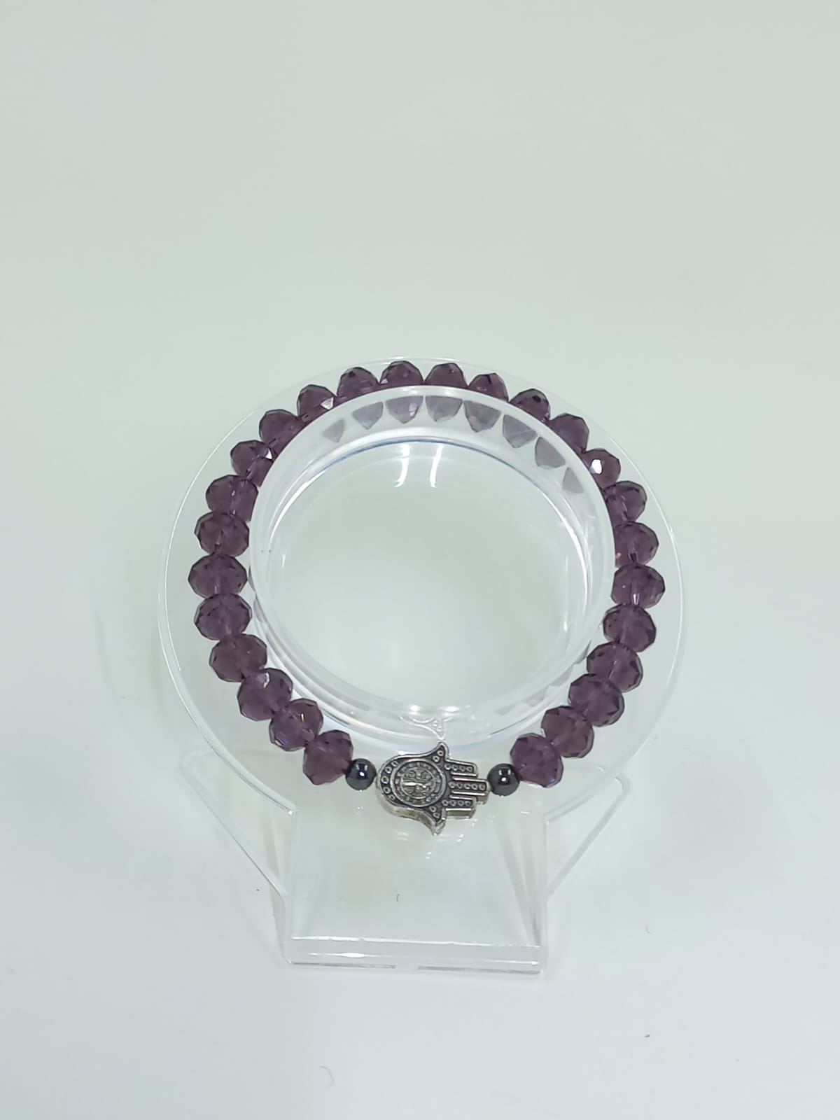Purple crystal bracelet with Hamsa and St. Benedict Hand charm.