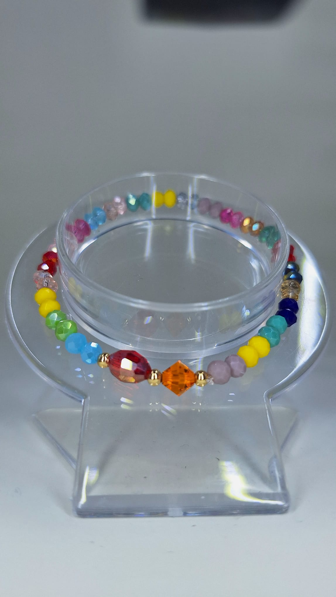 Colored crystal bracelet with gold laminated separator.