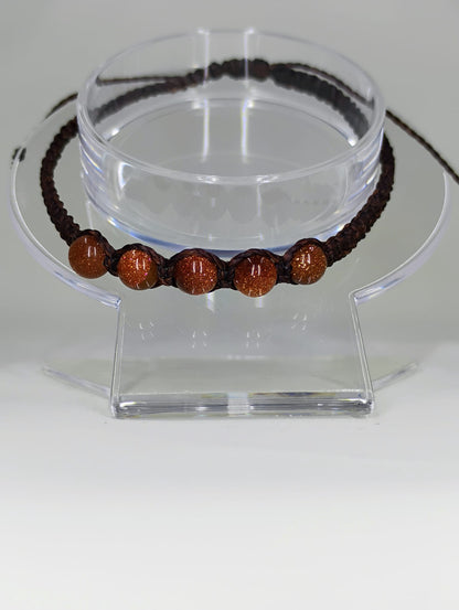 Hand-knitted bracelet in brown.