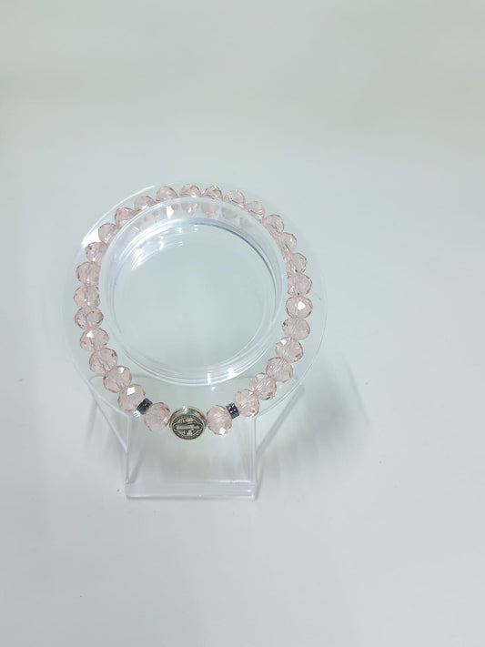 Pink crystal bracelet with St. Benedict charm.