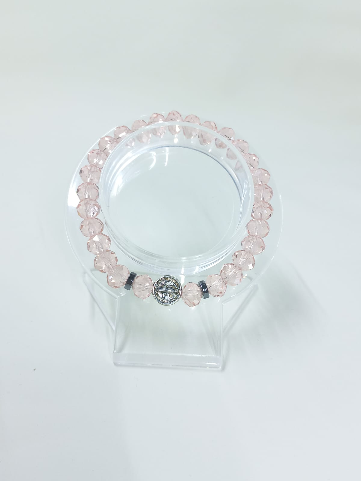 Pink crystal bracelet, with St. Benedict charm and flat metal spacers.