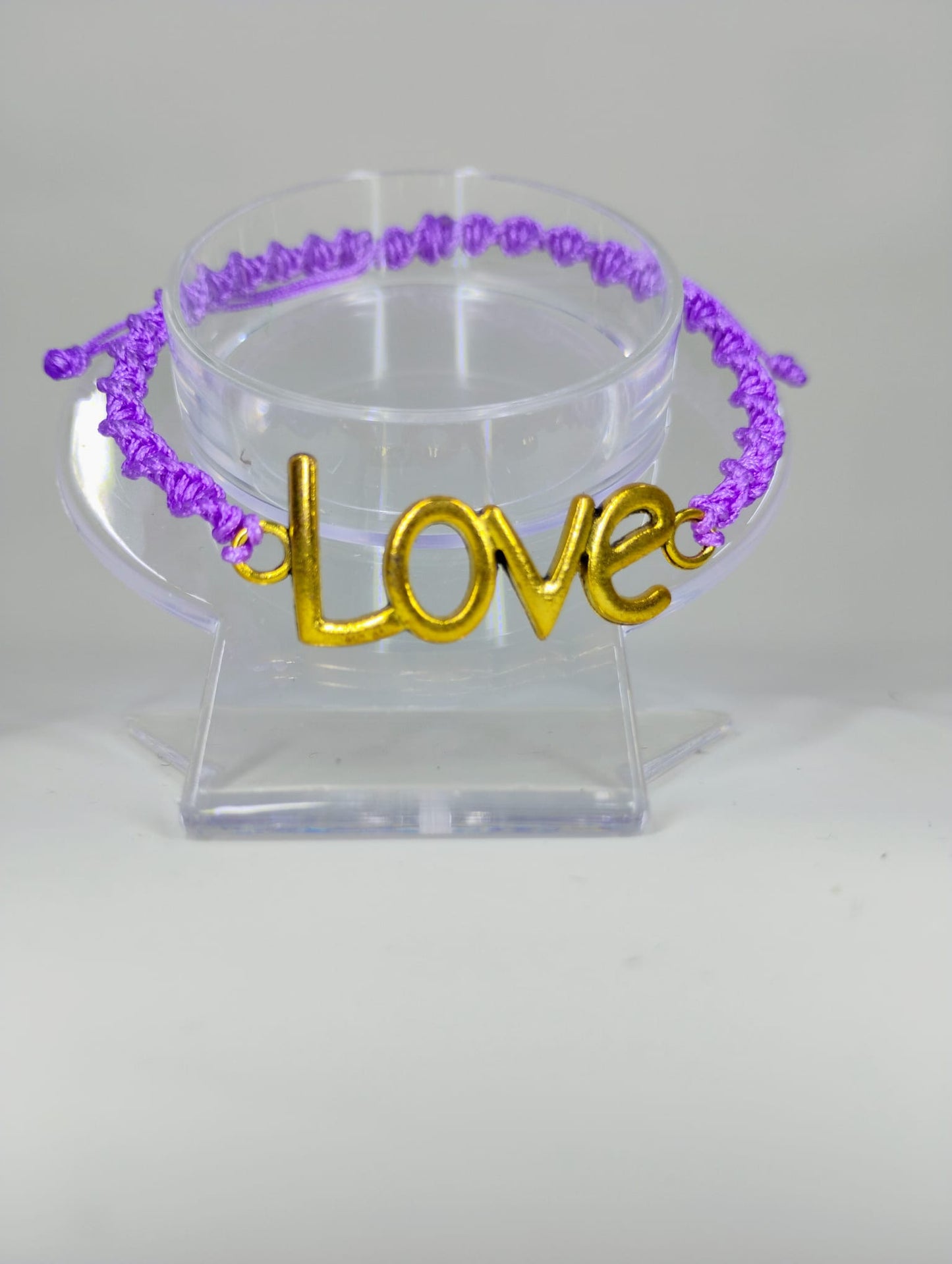 Hand-knitted bracelet, purple with Love metallic charm.