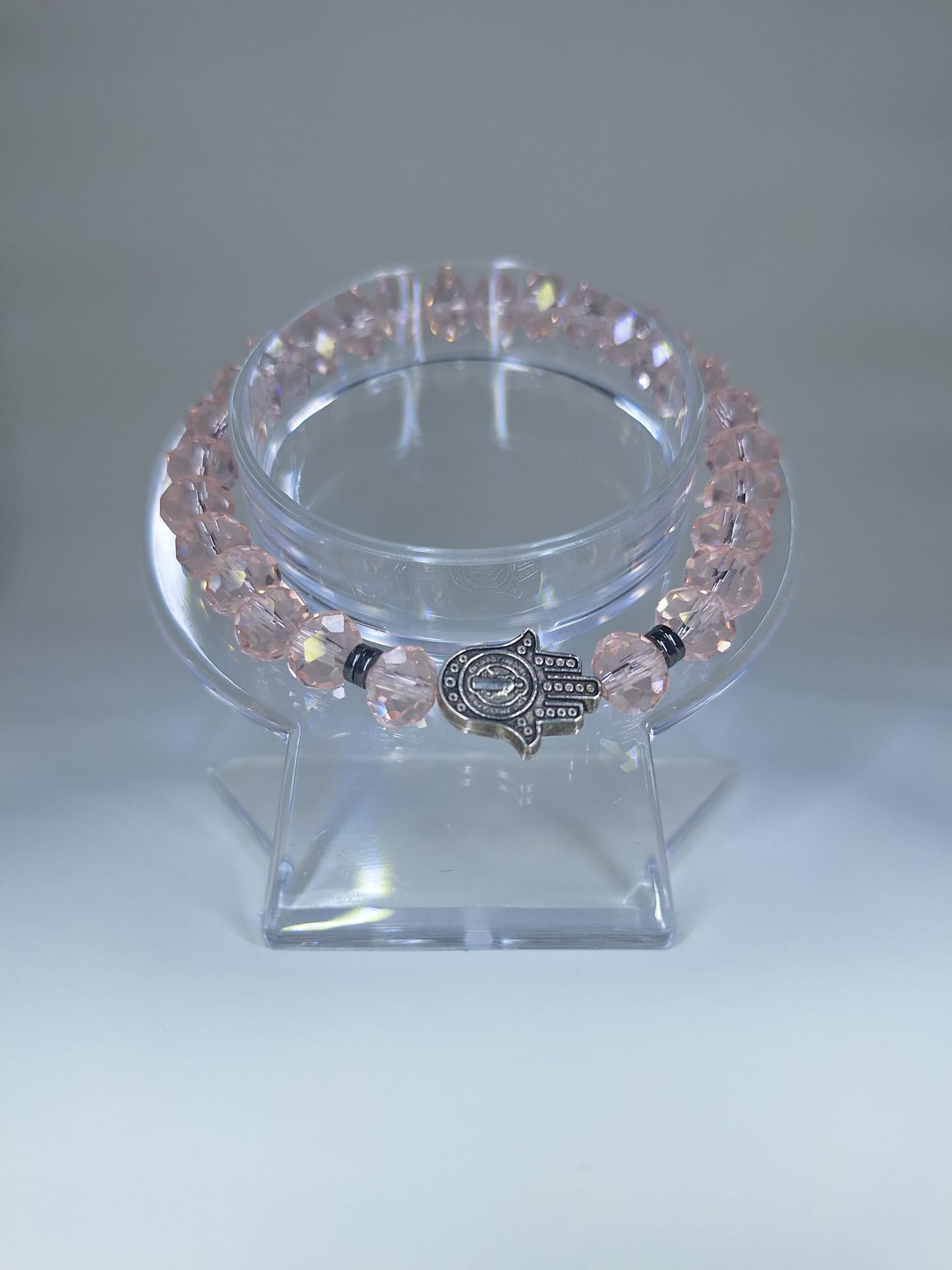 Pink crystal bracelet with Hamsa and St. Benedict Hand charm and flat separators.