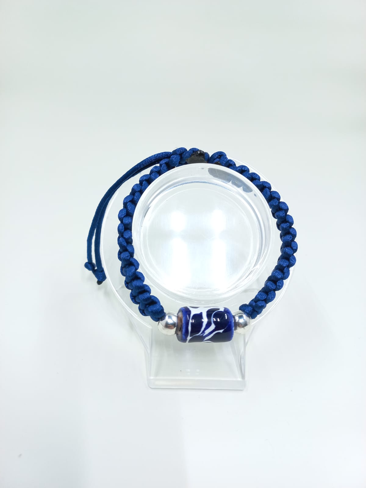 Hand-woven bracelet with Talavera cylinder charm, color blue.