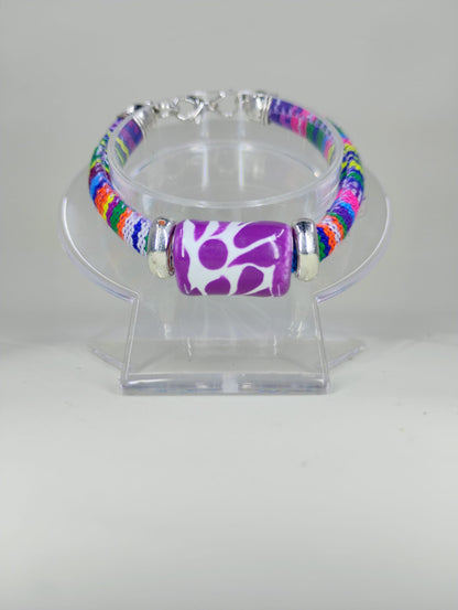 Multicolored textile bracelet, with Talavera cylinder charm, color purple, painted freehand from Mexico.