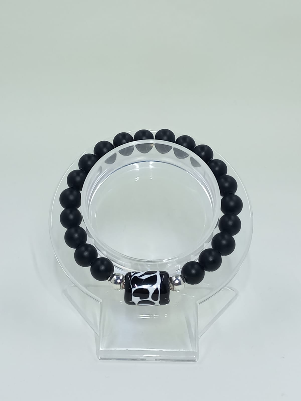 Black Onyx bracelet, with Talavera cylinder charm painted freehand, originally from Mexico.

Stainless Steel Ball Spacers.