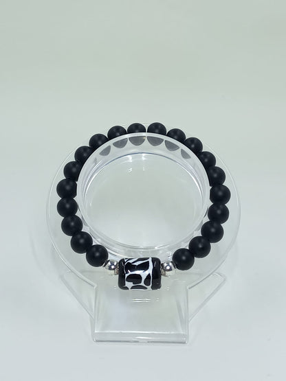 Black Onyx bracelet, with Talavera cylinder charm painted freehand, originally from Mexico.

Stainless Steel Ball Spacers.